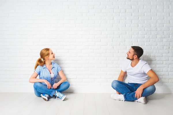 Concept of mortgage housing problems. couple at blank wall — Stock Photo, Image