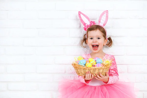 Happy child girl in a costume Easter bunny rabbit with basket of — Stock Photo, Image