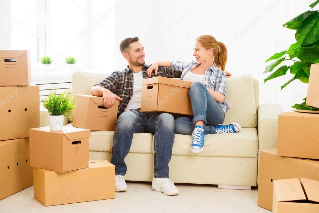 moving to a new apartment. Happy family couple and cardboard box