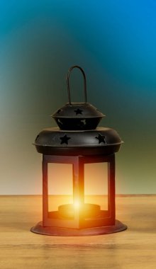 Yanan mumla süslenmiş Arapça bir fener. Bayram tebrik kartı. Müslümanların kutsal ayı ya da noeli için davetiye, Cadılar Bayramı bayramı