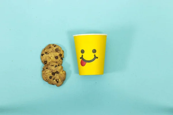 Tasting Food Face With Tongue Out and Chocolate Chip Cookies isolated on blue background
