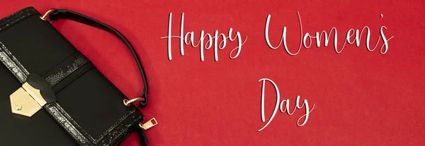 leather shoulder bag on red background. happy women\'s day