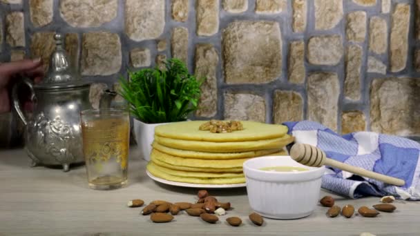 摩洛哥或阿尔及利亚薄饼 阿拉伯式 用蜂蜜糖浆装饰 配以核桃 杏仁和倒茶的妇女 — 图库视频影像