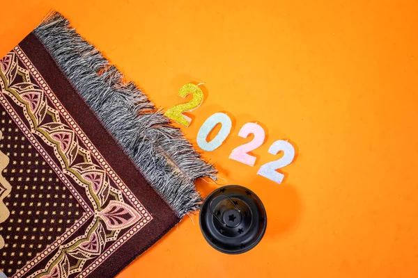 Arabic lantern with prayer mat and 2022 candle number, holiday concept