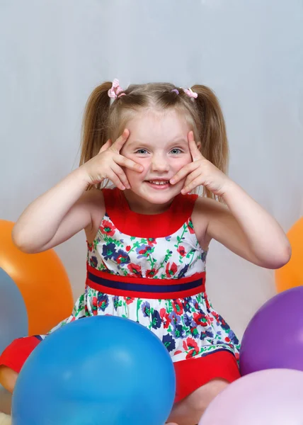 Portrait of a little girl playing with balls — Stock Photo, Image