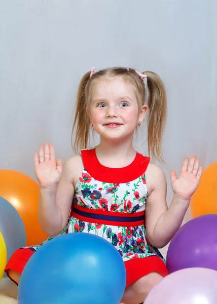 Portrait of a little girl playing with balls — Stock Photo, Image