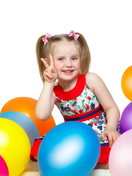 Portrait of a little girl playing with balls Stock Photo