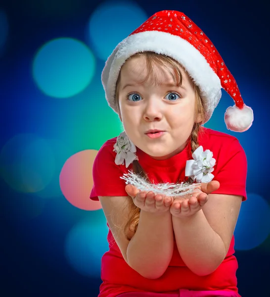 Menina vestida com um chapéu de Papai Noel em um backgrou abstrato — Fotografia de Stock