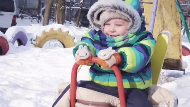Child on swing in winter — Stock Video