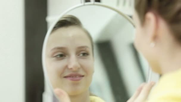 Menina depois de um corte de cabelo olha — Vídeo de Stock