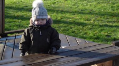 Tulumlu ve kış şapkalı bir çocuk.