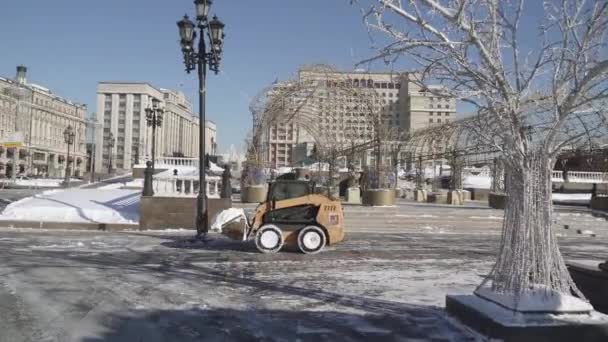 Remoção de neve pelos trabalhadores e um trator na Praça Manezhnaya após uma queda de neve pesada — Vídeo de Stock