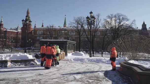 Snow removal by workers and a tractor on Manezhnaya Square after a heavy snowfall — Stock Video