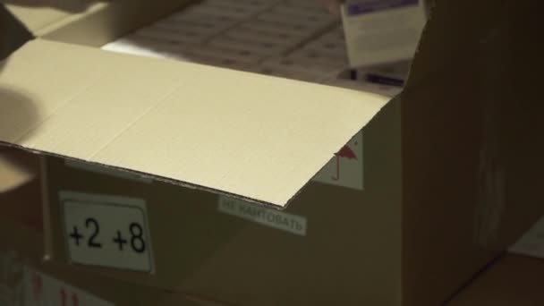 Kovivac vaccine packaging in the hands of a logistics company employee at the Kovivac storage warehouse — Stock Video