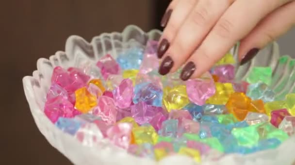 Mano tomando piedras de cristal de colores — Vídeo de stock