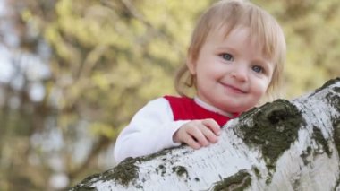 Huş ağacı üzerinde eğleniyor kız bebek
