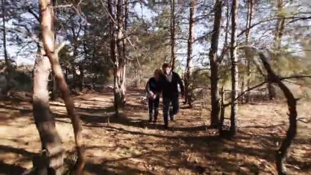 Casal correndo entre madeira — Vídeo de Stock
