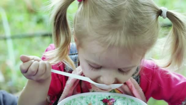 Girl eating with spoon — Stock Video