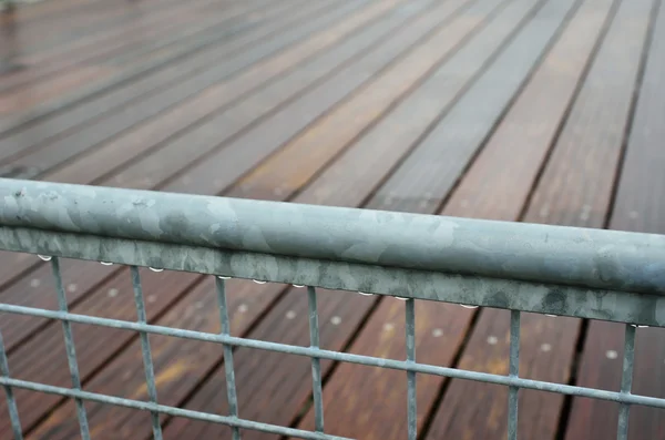 Wet railing of the wooden footway — Stock Photo, Image