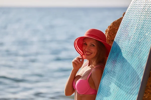 Charmante femme en chapeau sur fond d'océan, copier l'espace. Jour de plage, heure d'été, voyage de vacances et concept de sport de surf Images De Stock Libres De Droits