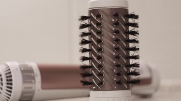 Close-up of hair Curling brushes. Concept. Barber takes attachment with bristles to tighten hair. Tips with bristles on hair dryer for drying and Curling hair — Stock Video