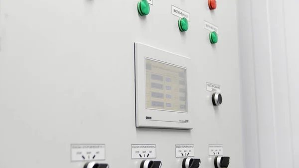 Close up of indicator lights on control panel at the factory. Media. Industrial plant boiler room control panel with buttons and signal lamps.