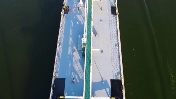 Top view of deck of cargo boat floating on river. Footage. Beautiful cargo boat with long spacious deck for large cargo. Inland freight water transport — Stock Photo, Image