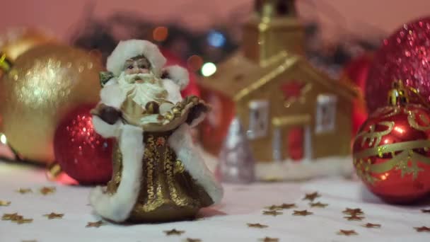 Juguete miniatura tradicional Papá Noel delante de guirnalda brillante y juguetes árbol de Navidad. Concepto. Primer plano de recuerdos y juguetes de Año Nuevo. — Vídeos de Stock