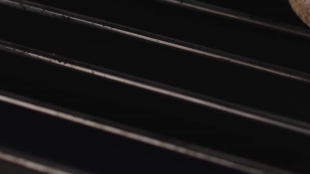 Close up of metal rods inside the oven with open fire. Stock footage. Dirty steel rods with fat isolated on black background with hot flame. — Stock Video
