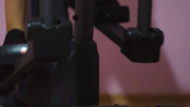 Adam yürüyen simülatörde çalışıyor. Kavram. Eliptik simülatörde çalışan erkek bacakları. Kardiyo yürüyüşü için bir basamak. Spor ve egzersiz ekipmanları