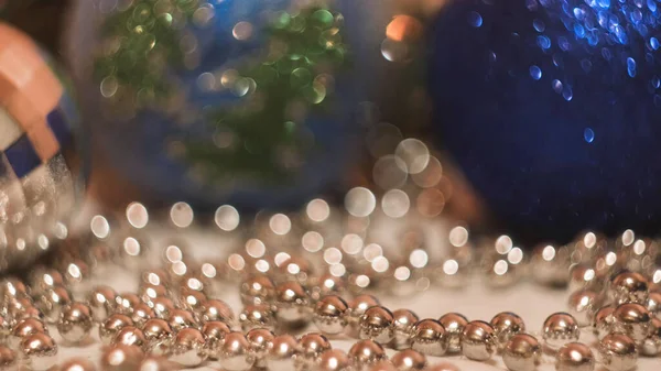 Close-up of woman taking Christmas toy. Concept. Womans hand takes beautiful Christmas ball to decorate Christmas tree. Shiny bright ball for Christmas tree — Stock Photo, Image