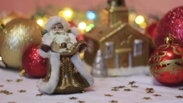 Les plus belles décorations d'arbres de Noël pour les vacances d'hiver. Concept. Gros plan de confettis, père Frost, une maison dorée et des jouets à billes. — Video
