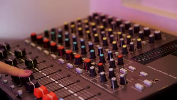 Sound producer hand is using a music mixer with editing tools. Media. Close up of female hand turning levers of a mixing console, concept of music production. — Stock Video