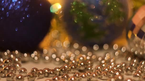 Festliche Komposition mit blauen und silbernen Weihnachtsbaumspielzeugen. Konzept. Blinkende verschwommene Girlanden und schöne kleine und große Bälle für ein glückliches neues Jahr. — Stockvideo