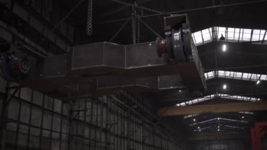Ağır endüstriyel tramvay taşıyan kapalı bir vinç fabrikasını kapatın. Şarjör. Maden fabrikasındaki atölyenin içine bak..