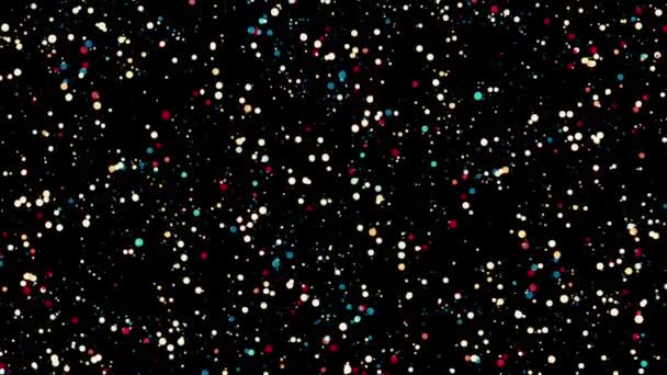Sokszínű konfetti vagy csillogó részecskék fekete háttér, zökkenőmentes hurok. Animáció. Két színes kör áramlik ellentétes irányba, és forog.. — Stock videók