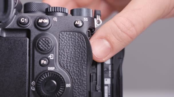 RUSSIA, MOSCOW-DECEMBER, 2020: Close-up of removing memory card from camera. Action. Replacing memory card in camera. Photographer takes completed memory card out of camera — Stock Video