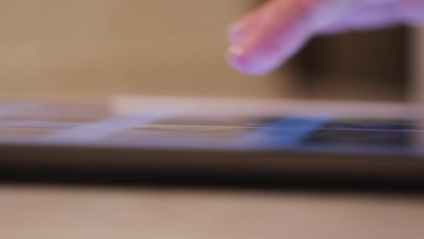 Frau nutzt digitalen Tablet-Computer zu Hause. Konzept. Nahaufnahme von weiblichen Händen mit modernem Tablet und Scrollen mit dem Finger. — Stockvideo