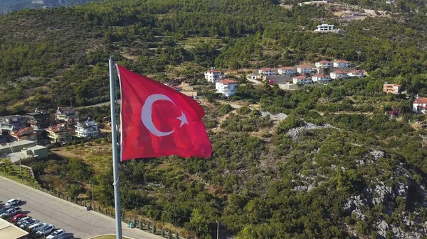 Panorama of Alanya resort city with residential complex on a summer sunny day. Clip. Aerial view of a red Turkey flag and green hills, concept of vacation. — Stock Photo, Image