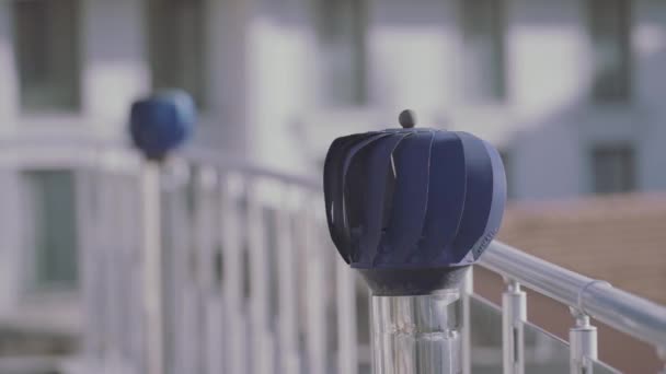 Dois moinhos de vento pequenos azuis rotativos em uma forma de esfera ao ar livre na varanda. Acção. Decoração do terraço de uma casa residencial. — Vídeo de Stock