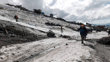 Bir grup dağcı, Mt. Dağın buzlu yamacına tırmanıyor. Everest gökyüzünde. Şarjör. İnsanlar karlı bir yola tırmanmaktan zevk alıyor..
