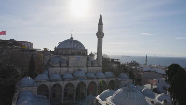 Beautiful mosque in Istanbul on background of sea. Action. Beautiful historical architecture and mosque of Turkish city located on coast of sea. Mosque in Istanbul on background of sea horizon on — Stock Video