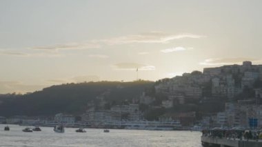 Açık havada güzel bir rıhtım ve kasaba manzarası. Başla. Liman kenti ve açık gökyüzünün arka planında kıyıya doğru giden gemiler. Martılar deniz kenti açıklarında uçar.