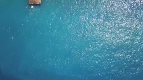 푸른 바다와 나무로 된 부두가 공중에 떠 있는 모습. 클립. 야외에서 일광욕을 즐기는 사람들과 함께 있는 샌디 해변, 여름 방학의 개념. — 비디오
