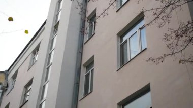 Sonbaharda konut binasının dışı. Stok görüntüleri. Açık bir sonbahar gününde güzel görünüşlü sıradan bir apartman. Güzel bir bina cephesi.