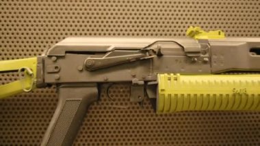 Silahlar duvarda asılı. Stok görüntüleri. Duvarda farklı tipte renkli silahlar asılı. Ateş etmek için silahlarla dolu duvar. Paintball ya da hava yumuşağı oynamak için silahlarla dolu bir duvar.