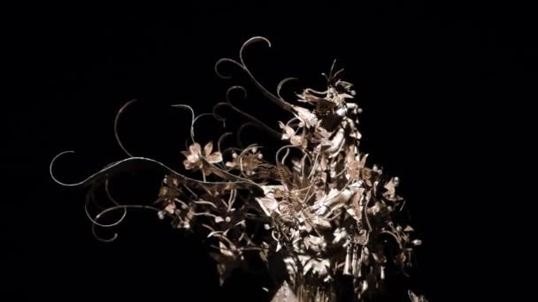 Saint Petersburg - Russia, 01.02.2021: exhibition of unusual art hats of Philip Treacy in Erarta museum. Concept. Unusual female bonnet made of gold plated artificial flowers isolated on black — Stock Video