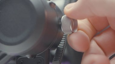 Hand twisting screw on plastic installation. Action. Close-up of hand fixing valve for stability of installation. Tightening screw for stability of stabilizer