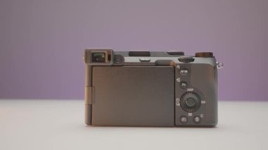 Back of camera on isolated background. Action. Closed camera display on isolated background. Camera is on table with closed display