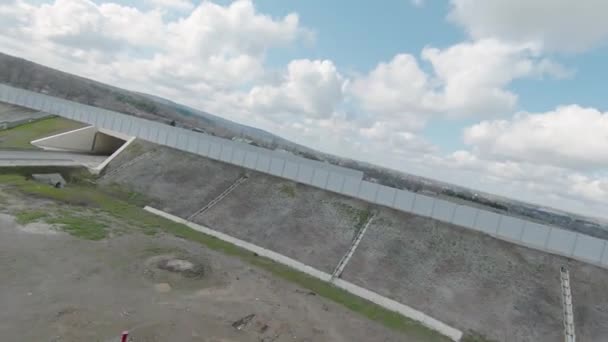 Flying drone on country road with tunnel. Shot. Beautiful panorama with country highway and drone following car. Top view with drone following car on motorway — Stock Video